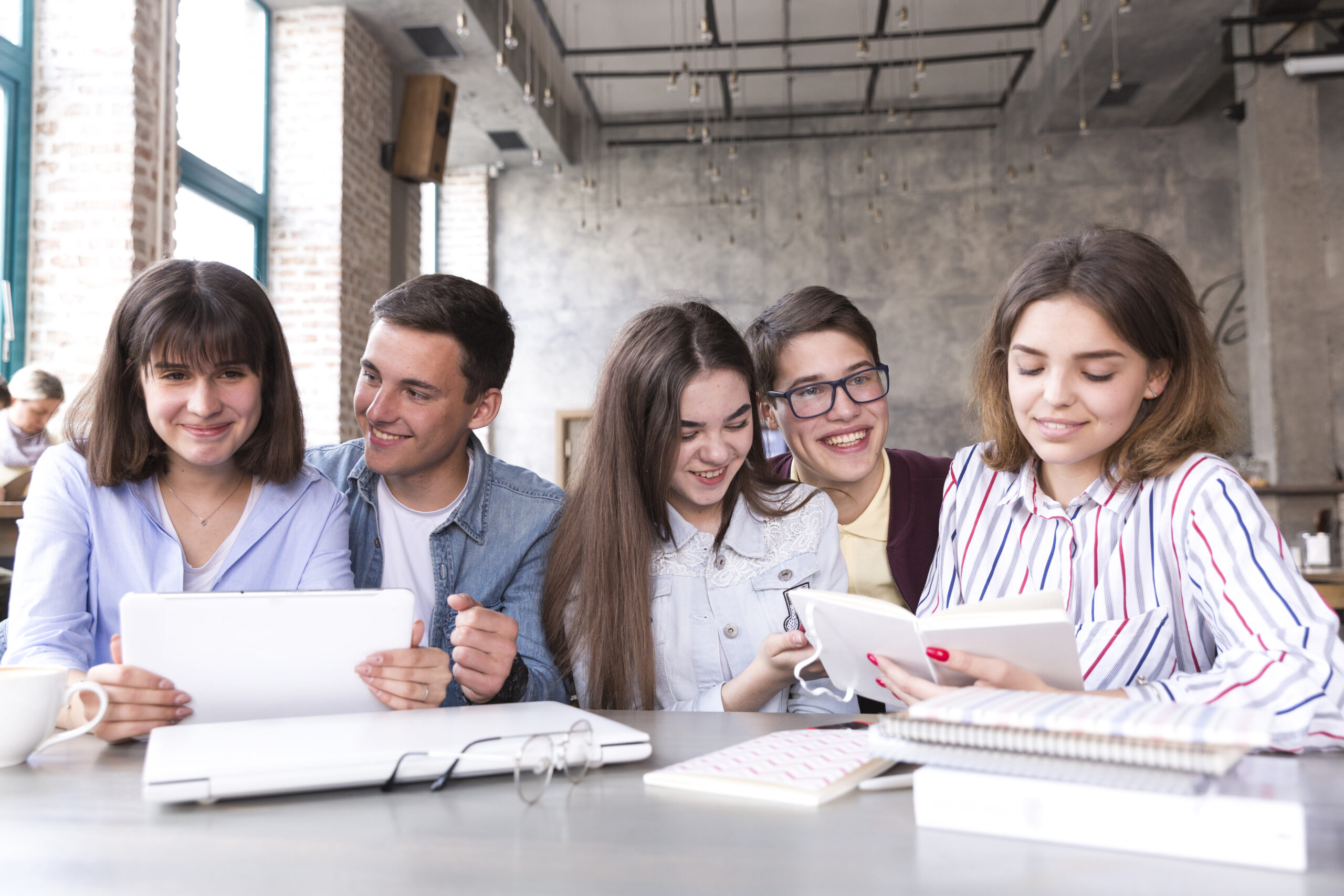 Students Sitting Table Studying With Books Tablet